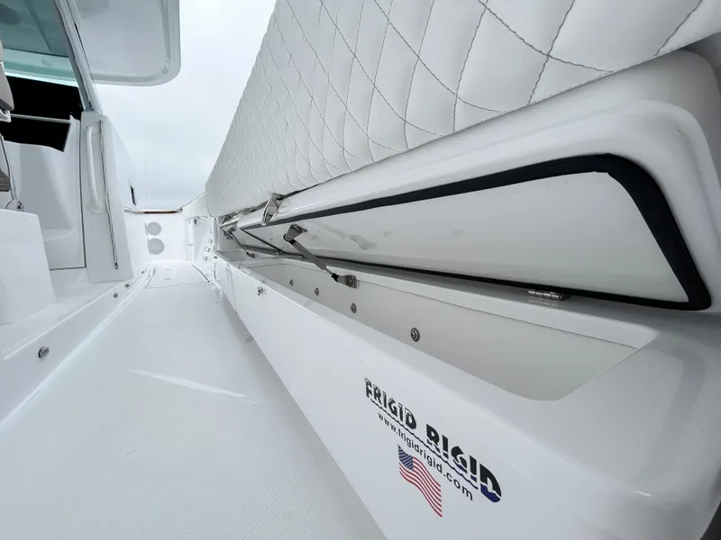 Slide: The Image of HCB 48 Campeon 2025 boat interior with quilted seating and storage compartment. - 41