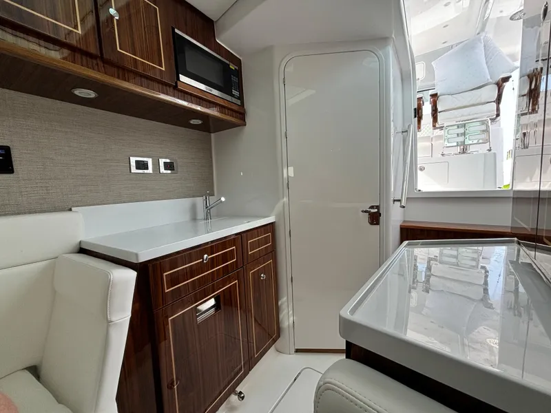 Slide: The Image of Interior of 2025 HCB 48 CAMPEON yacht with modern kitchen and seating area. - 69