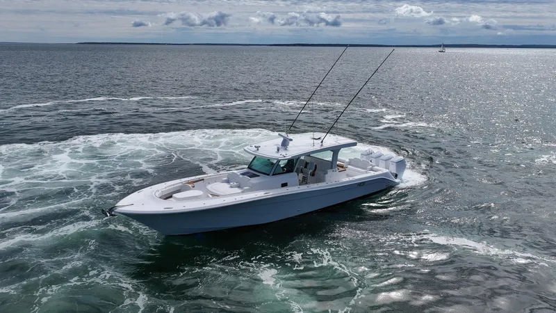 Slide: The Image of 2025 HCB 48 Campeon boat cruising on open water. - 7