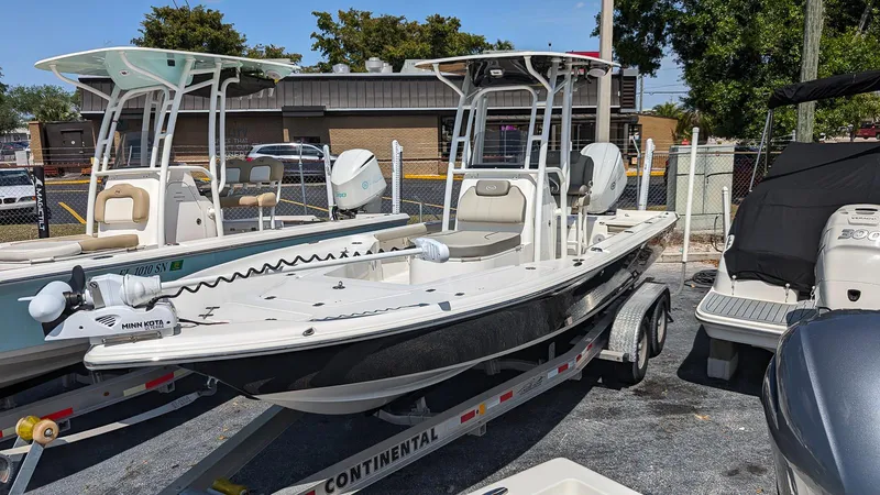 Slide: The Image of 2023 Key West 250 Bay Reef boat on a Continental trailer in a marina. - 1