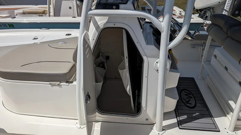 Slide: The Image of 2023 Key West 250 Bay Reef boat interior with open storage compartment. - 13