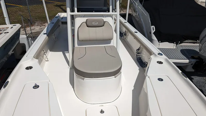 Slide: The Image of 2023 Key West 250 Bay Reef boat interior with seating and storage compartments. - 14