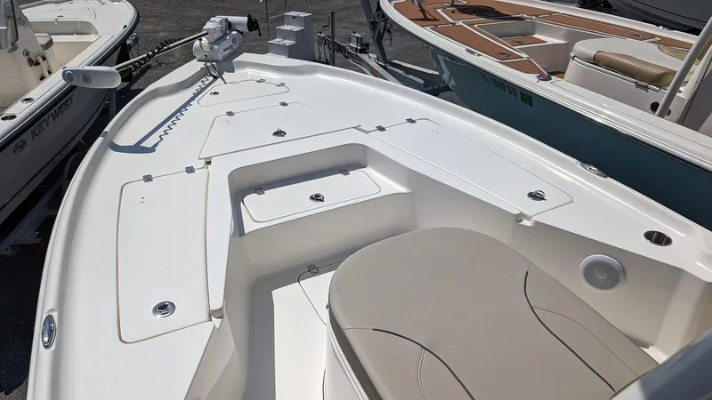 Slide: The Image of 2023 Key West 250 Bay Reef boat interior with seating and storage compartments. - 16