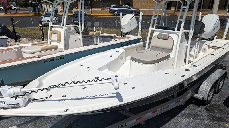 Slide: The Image of 2023 Key West 250 Bay Reef boat on a trailer in a marina. - 3