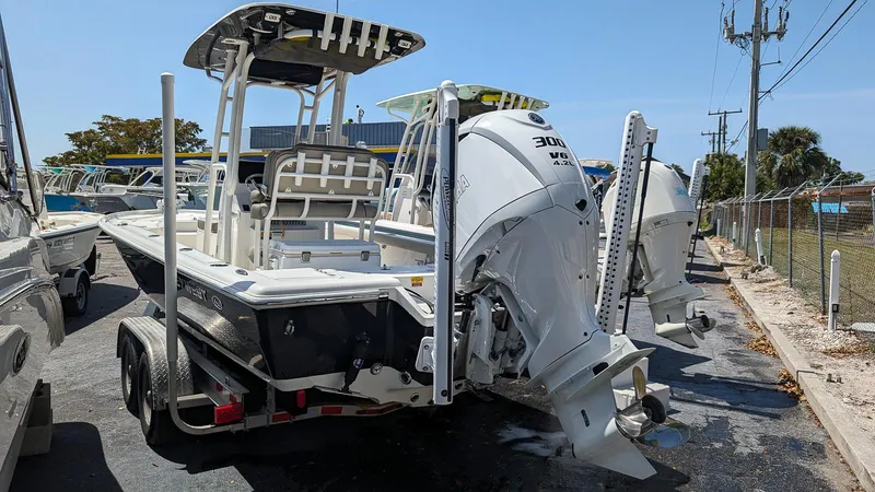 Slide: The Image of 2023 Key West 250 Bay Reef boat with dual outboard engines on a trailer. - 5