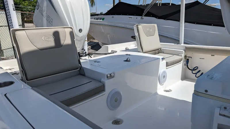 Slide: The Image of 2023 Key West 250 Bay Reef boat interior with cushioned seating and storage compartments. - 7