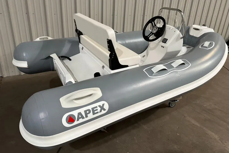 The Image of 2024 Apex A-10 Eurosport Rib Gallery inflatable boat, gray and white, in a warehouse setting. - 0