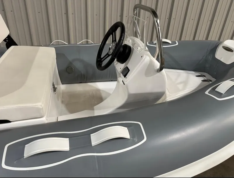 Slide: The Image of 2024 Apex A-10 Eurosport Rib Gallery boat interior with steering wheel and seating. - 2