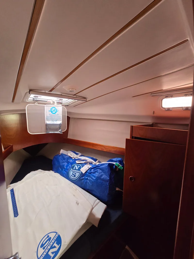 Slide: The Image of Interior cabin of 1995 Beneteau Oceanis 351 sailboat with storage and bedding. - 10
