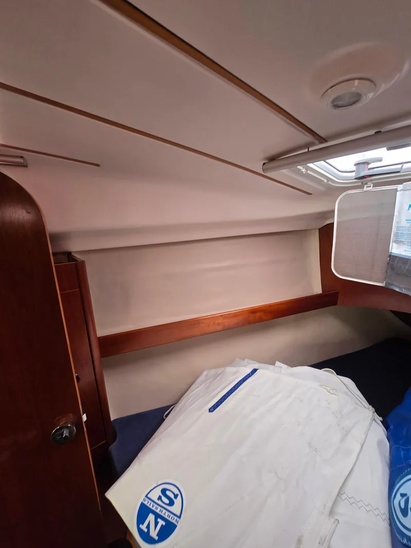 Slide: The Image of Interior cabin of 1995 Beneteau Oceanis 351 sailboat with bedding and storage. - 11