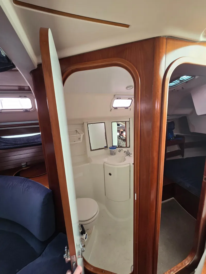 Slide: The Image of Interior of 1995 Beneteau Oceanis 351 sailboat, featuring a compact bathroom. - 12