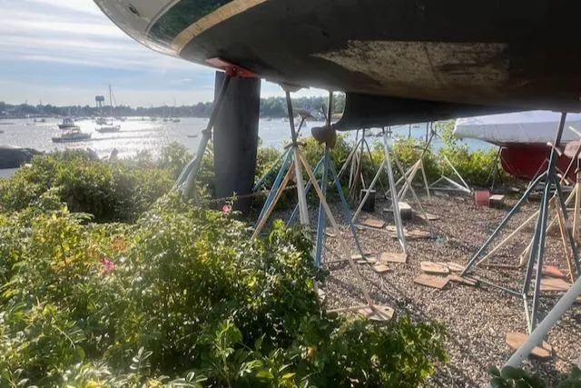 Slide: The Image of Beneteau Oceanis 351 sailboat on stands, overlooking a scenic waterfront, sunny day. - 26