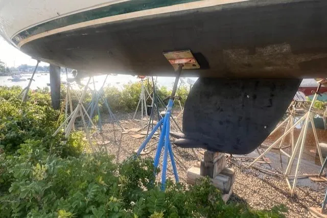 Slide: The Image of 1995 Beneteau Oceanis 351 sailboat on stands, showing keel and hull in a boatyard. - 27