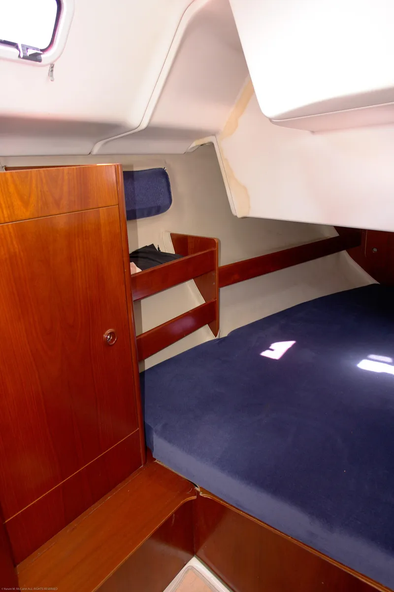 Slide: The Image of Interior cabin of a 1995 Beneteau Oceanis 351 sailboat with wooden furnishings. - 3