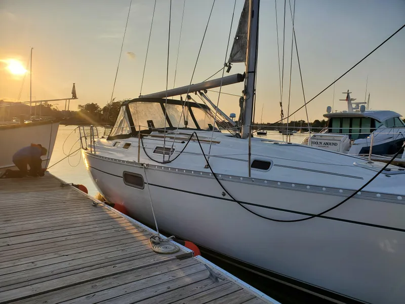 Slide: The Image of 1995 Beneteau Oceanis 351 sailboat docked at sunset, calm waters, serene atmosphere. - 30