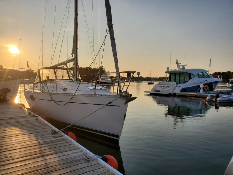 Slide: The Image of Sailboat Beneteau Oceanis 351 docked at sunset, calm waters, 1995 model. - 31