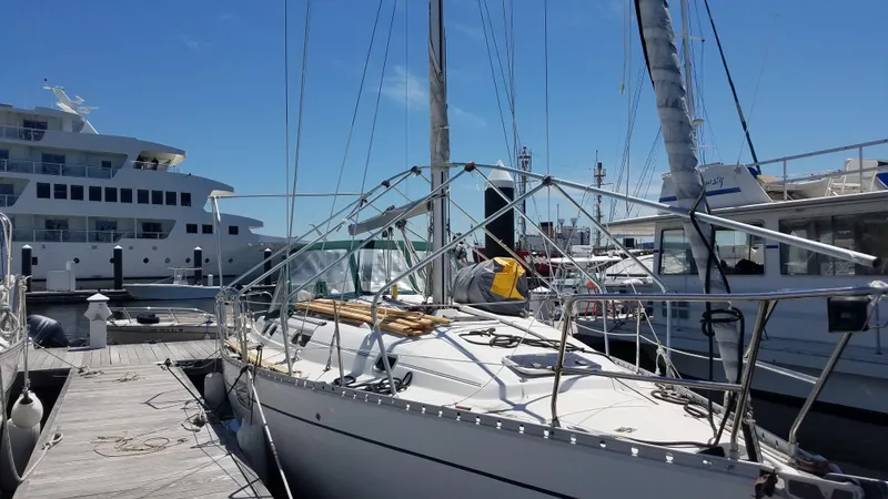 Slide: The Image of 1995 Beneteau Oceanis 351 sailboat docked at marina under clear blue sky. - 35