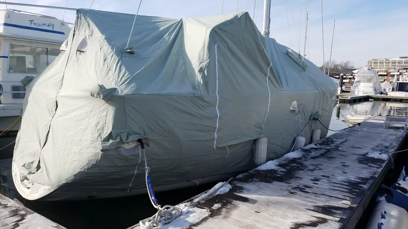 Slide: The Image of Covered 1995 Beneteau Oceanis 351 sailboat docked in a marina during winter. - 37