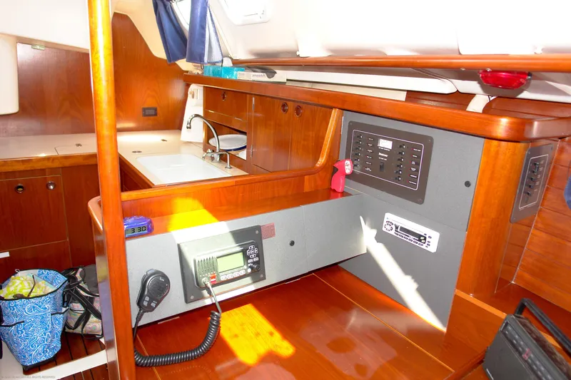 Slide: The Image of Interior of 1995 Beneteau Oceanis 351 sailboat with navigation equipment and wooden cabinetry. - 7