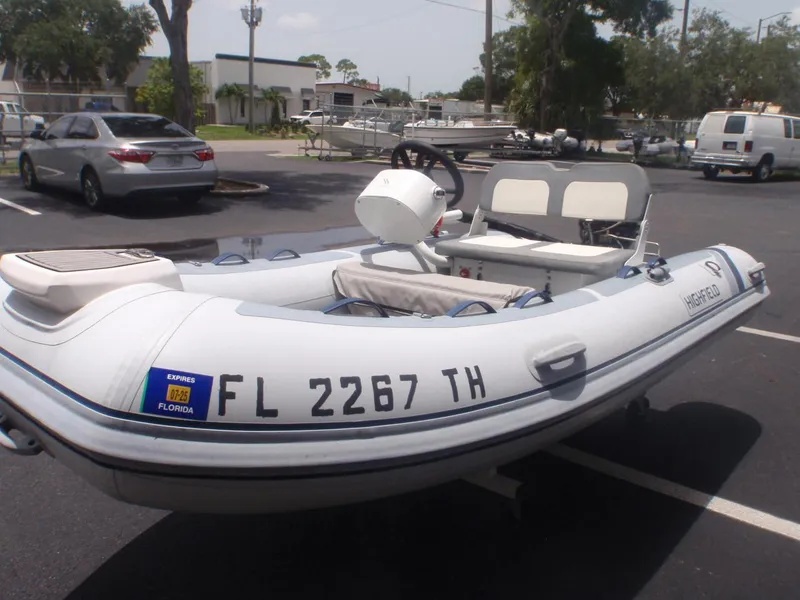 Slide: The Image of 2022 Highfield Classic 340 FCT inflatable boat in a parking lot. - 2