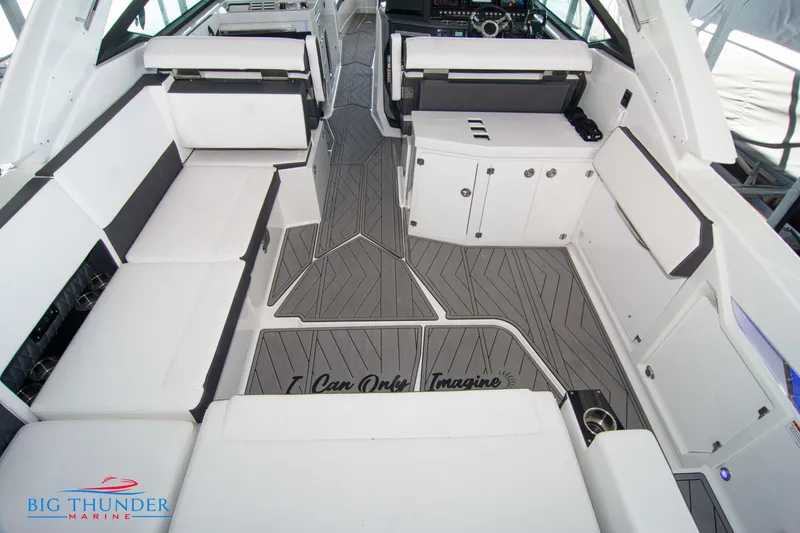 Slide: The Image of 2022 Monterey 378 SS boat interior with white seating and gray flooring. - 17