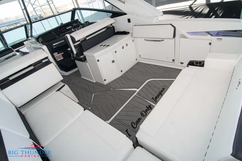 Slide: The Image of 2022 Monterey 378 SS boat interior with white seating and modern dashboard. - 18