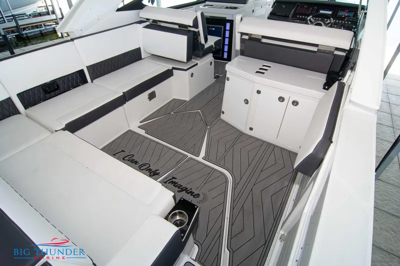 Slide: The Image of 2022 Monterey 378 SS boat interior with white seating and modern dashboard. - 19