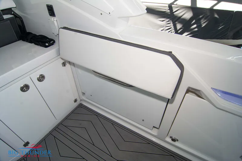 Slide: The Image of 2022 Monterey 378 SS boat interior with storage compartments and cushioned seating. - 22