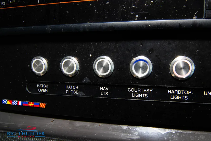 Slide: The Image of Control panel of a 2022 Monterey 378 SS boat with various switches. - 38