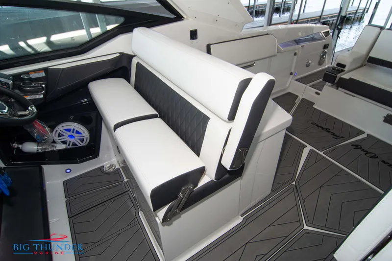 Slide: The Image of 2022 Monterey 378 SS boat interior with white and black seating, modern dashboard, and Big Thunder Marine logo. - 48