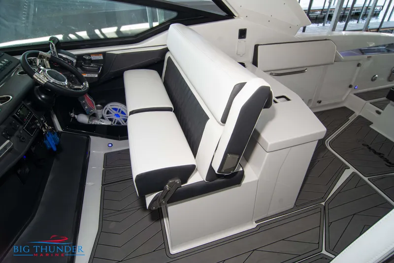 Slide: The Image of 2022 Monterey 378 SS boat interior with white and black seating, steering wheel, and modern dashboard. - 49