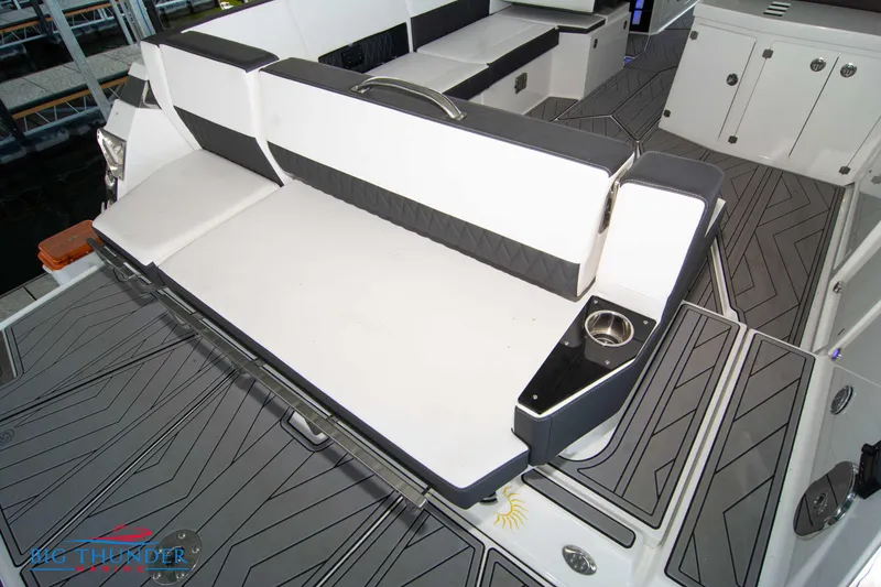 Slide: The Image of 2022 Monterey 378 SS boat interior with cushioned seating and cup holders. - 9