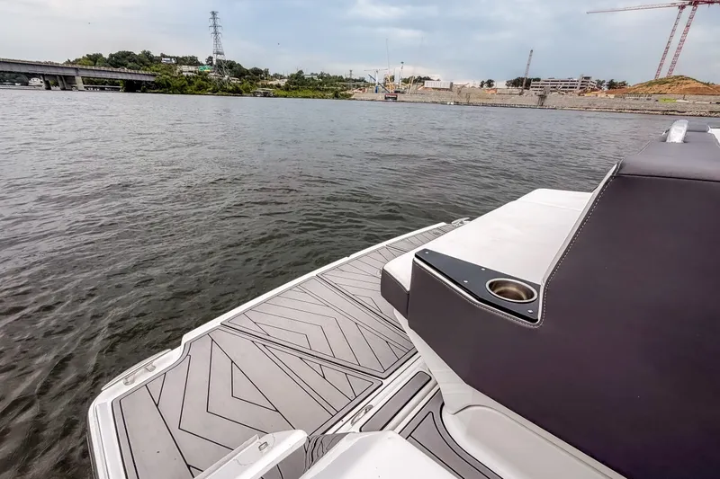 Slide: The Image of 2022 Monterey 378SS Super Sport boat on a calm river near a bridge and construction site. - 38