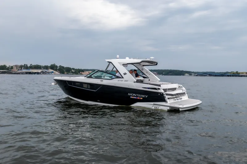 Slide: The Image of 2022 Monterey 378SS Super Sport boat cruising on a lake under cloudy skies. - 7