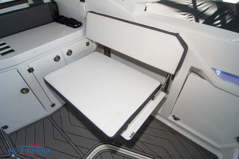 Slide: The Image of 2022 Monterey 378 SS boat interior with foldable seat and storage cabinets. - 23