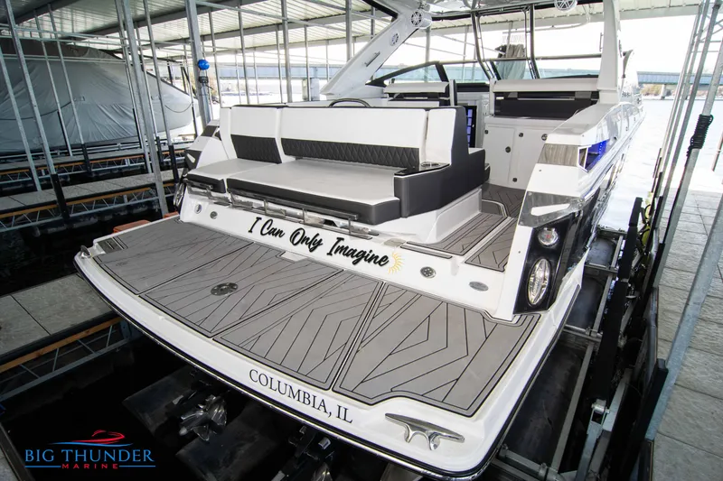 Slide: The Image of 2022 Monterey 378 SS boat docked at marina, rear view with seating area. - 8