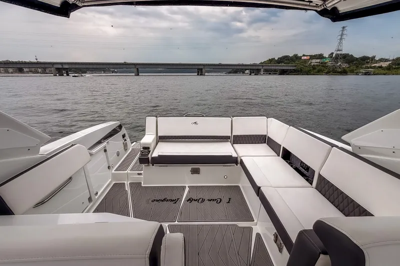 Slide: The Image of 2022 Monterey 378SS Super Sport boat interior with luxurious seating on a calm river. - 20