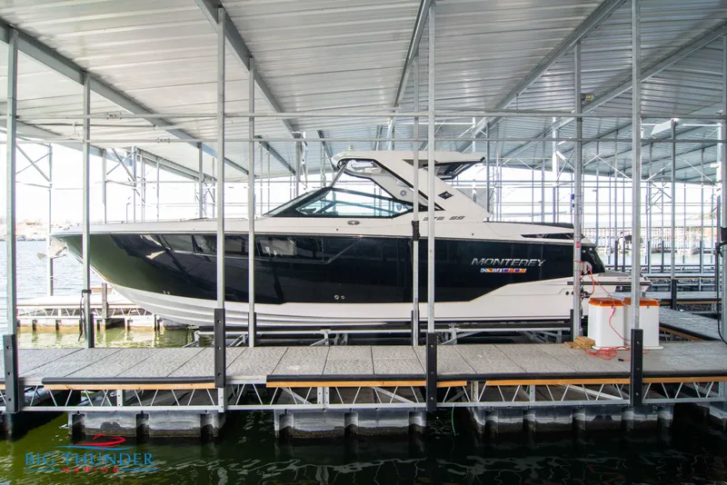 The Image of 2022 Monterey 378 SS boat docked in a covered marina. - 1