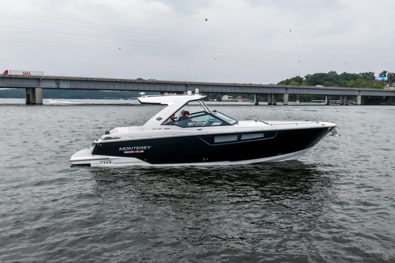 Slide: The Image of 2022 Monterey 378SS Super Sport boat cruising on a river near a bridge. - 3