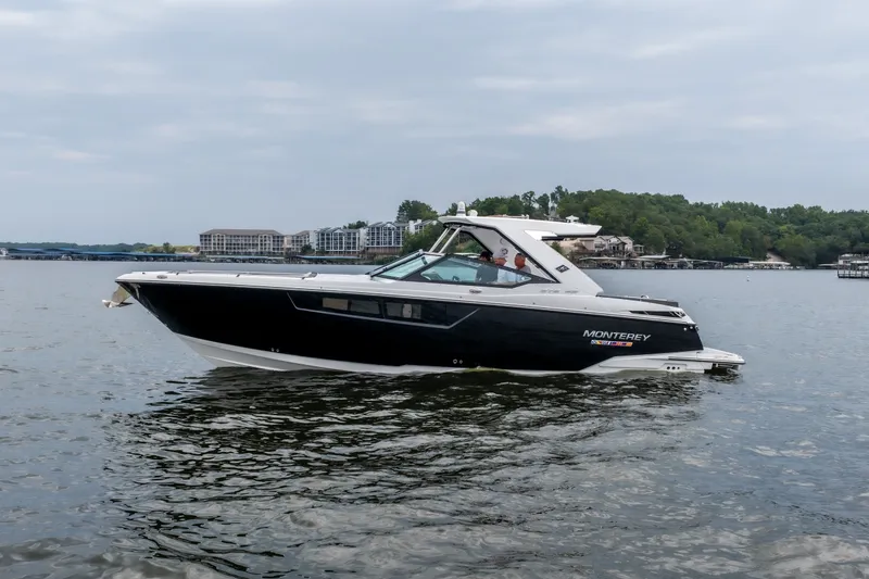 Slide: The Image of 2022 Monterey 378SS Super Sport boat cruising on a lake with scenic background. - 46