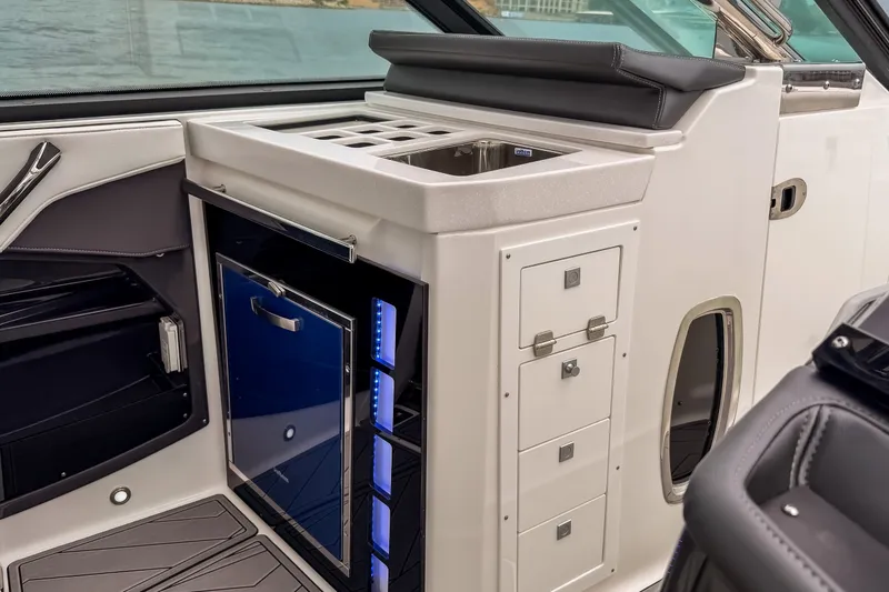 Slide: The Image of Interior of 2022 Monterey 378SS Super Sport boat with sleek kitchenette and storage. - 17