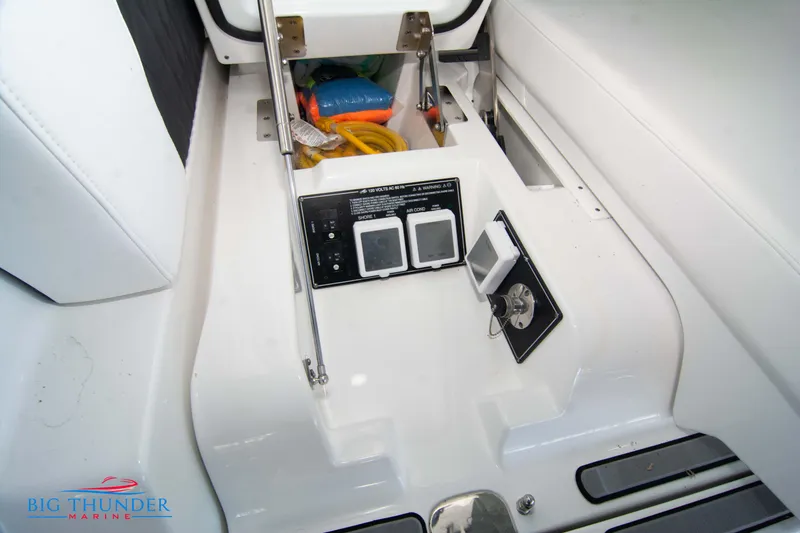 Slide: The Image of 2022 Monterey 378 SS boat storage compartment with control panel and safety equipment. - 13
