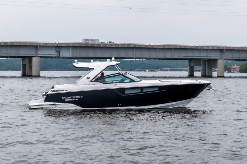 The Image of 2022 Monterey 378SS Super Sport boat cruising on a river near a bridge. - 1