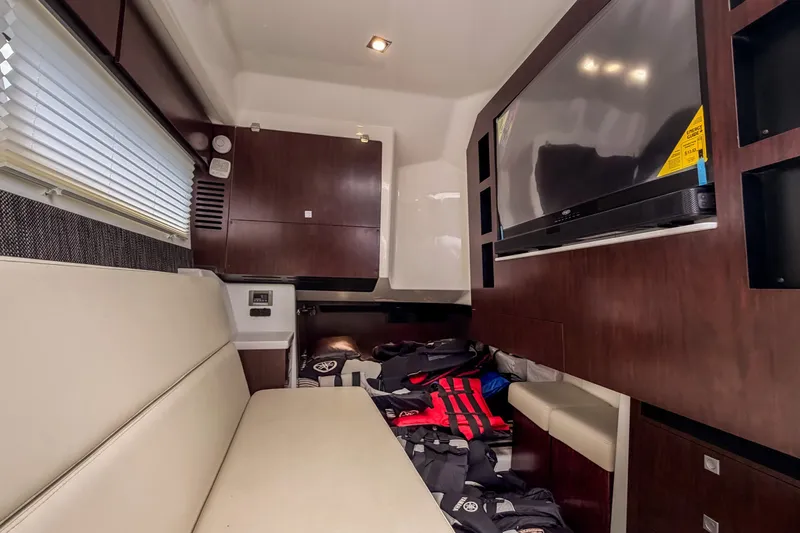 Slide: The Image of Interior of 2022 Monterey 378SS Super Sport boat with seating, TV, and storage. - 31