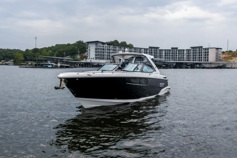 Slide: The Image of 2022 Monterey 378SS Super Sport boat on a lake with modern buildings in the background. - 4