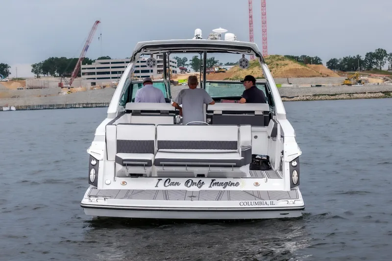 Slide: The Image of 2022 Monterey 378SS Super Sport boat on water, rear view with passengers. - 6