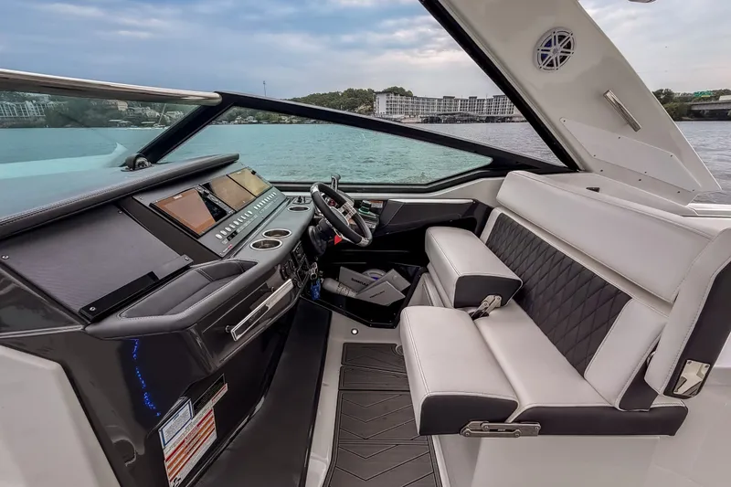 Slide: The Image of 2022 Monterey 378SS Super Sport boat interior with modern dashboard and luxurious seating. - 18