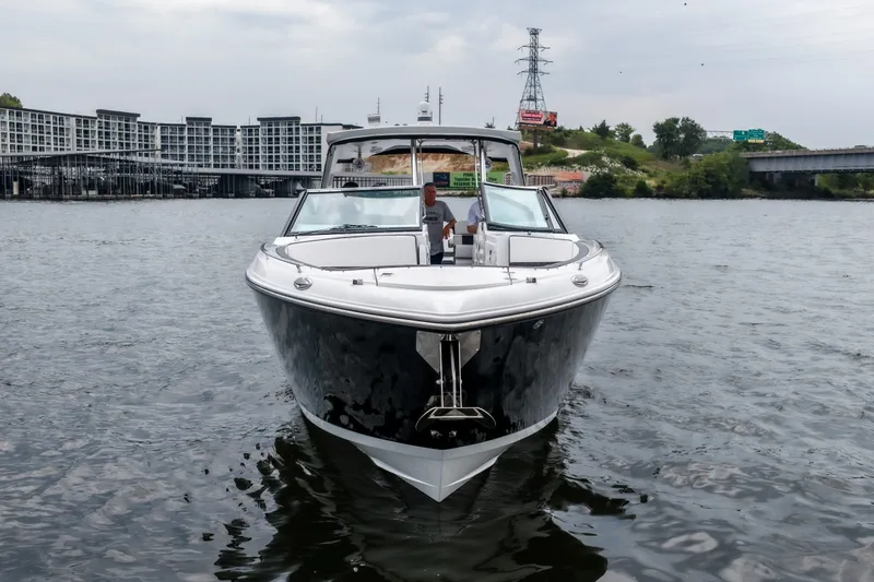 Slide: The Image of 2022 Monterey 378SS Super Sport boat on water, urban backdrop, overcast sky. - 5