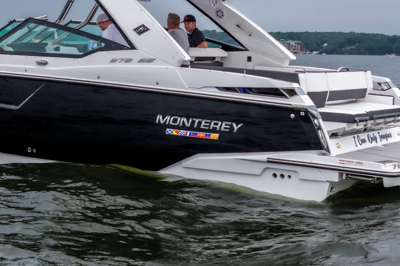 Slide: The Image of 2022 Monterey 378SS Super Sport boat cruising on a lake with passengers onboard. - 9