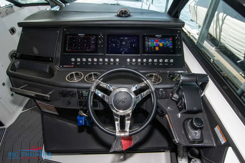 Slide: The Image of 2022 Monterey 378 SS boat dashboard with steering wheel and control panel. - 33